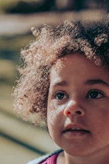 A close-up portrait of a child smiling with natural light.
