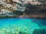 Tourists enjoying a peaceful moment by the crystal-clear waters of the Jeita Grotto