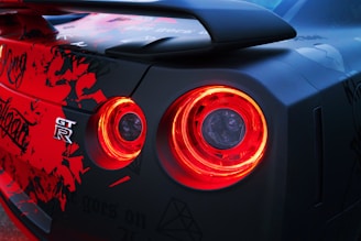 Side view of a Nissan Skyline GT-R with a vibrant blue and pink livery.