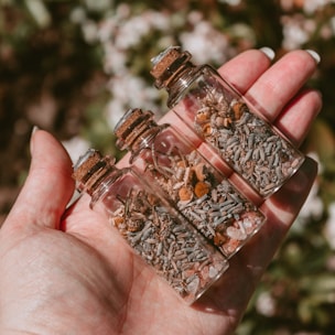 corked, clear glass bottles with witchcraft ingredients inside