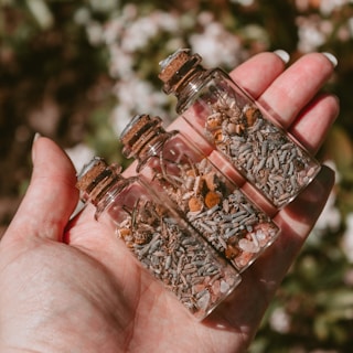 corked, clear glass bottles with witchcraft ingredients inside