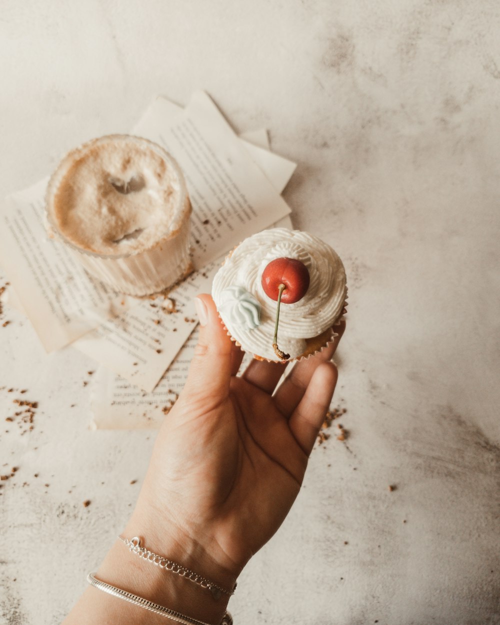 person holding white and brown doughnut