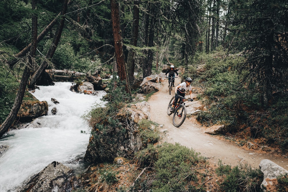 man riding bicycle on river during daytime