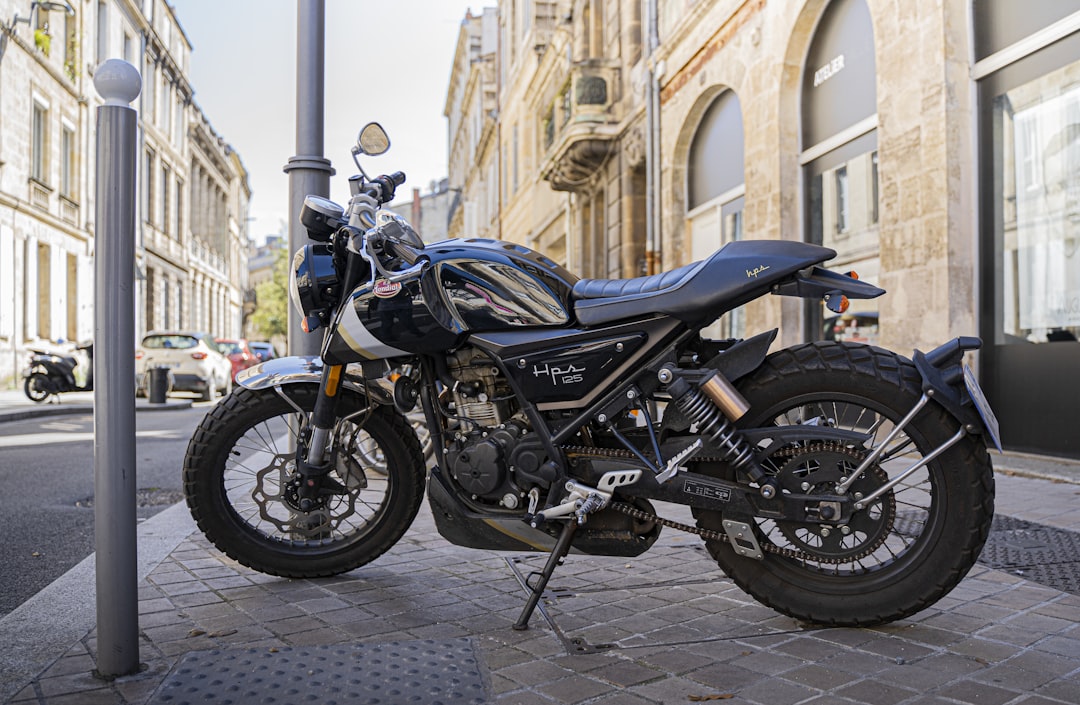 black and blue standard motorcycle parked on sidewalk during daytime