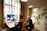 Teacher engaging with students through an online video call in a bright, welcoming room.