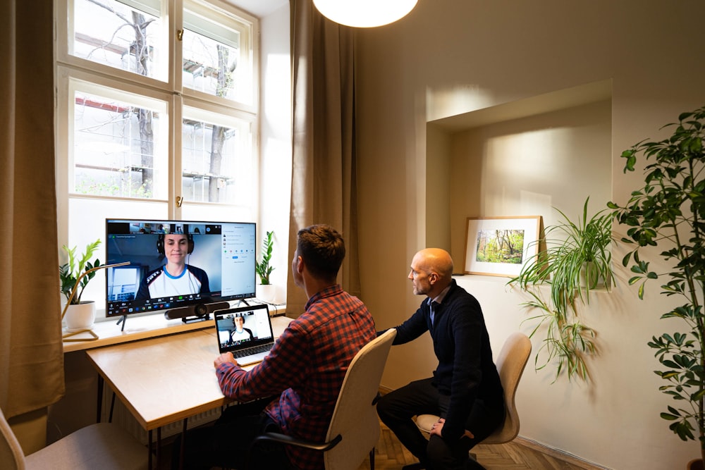 man in black long sleeve shirt sitting on chair in front of computer