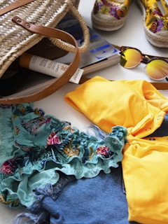 brown and black sunglasses on yellow textile