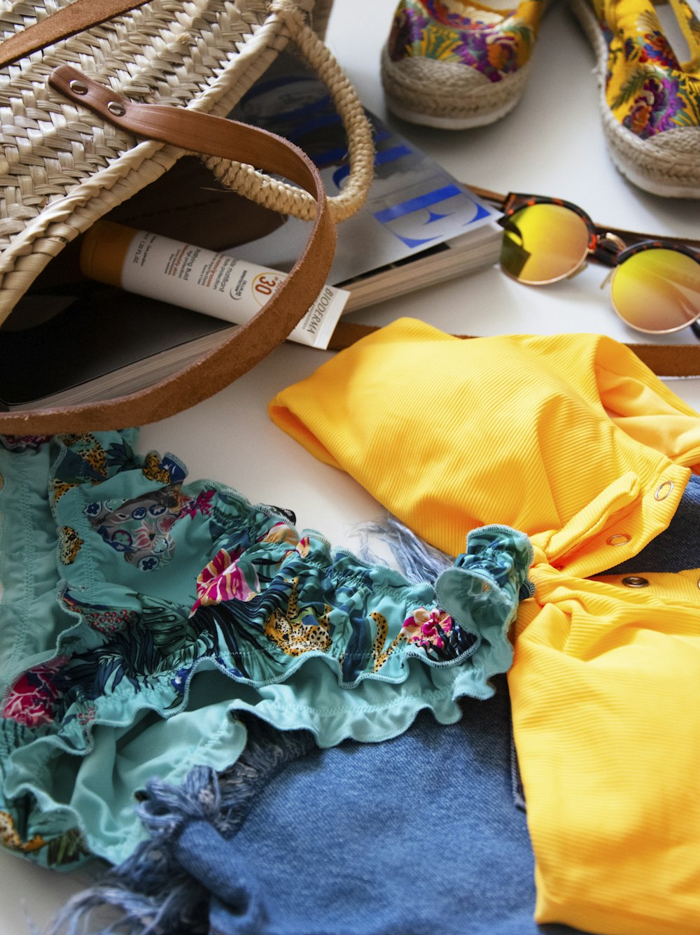 brown and black sunglasses on yellow textile