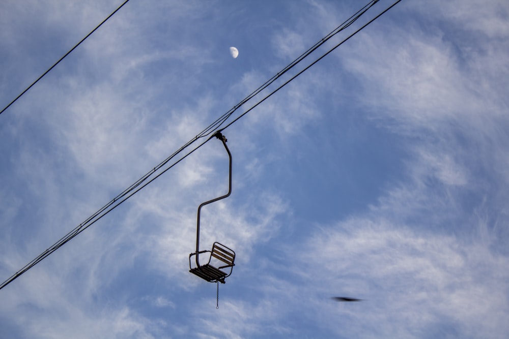 black and white basketball hoop under blue sky and white clouds during daytime