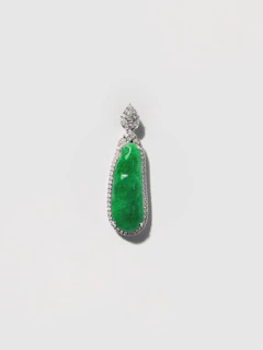 A delicate silver pendant showcasing a deep green natural gemstone from the Swat valley.