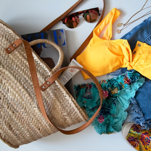 blue denim jeans beside yellow leather handbag