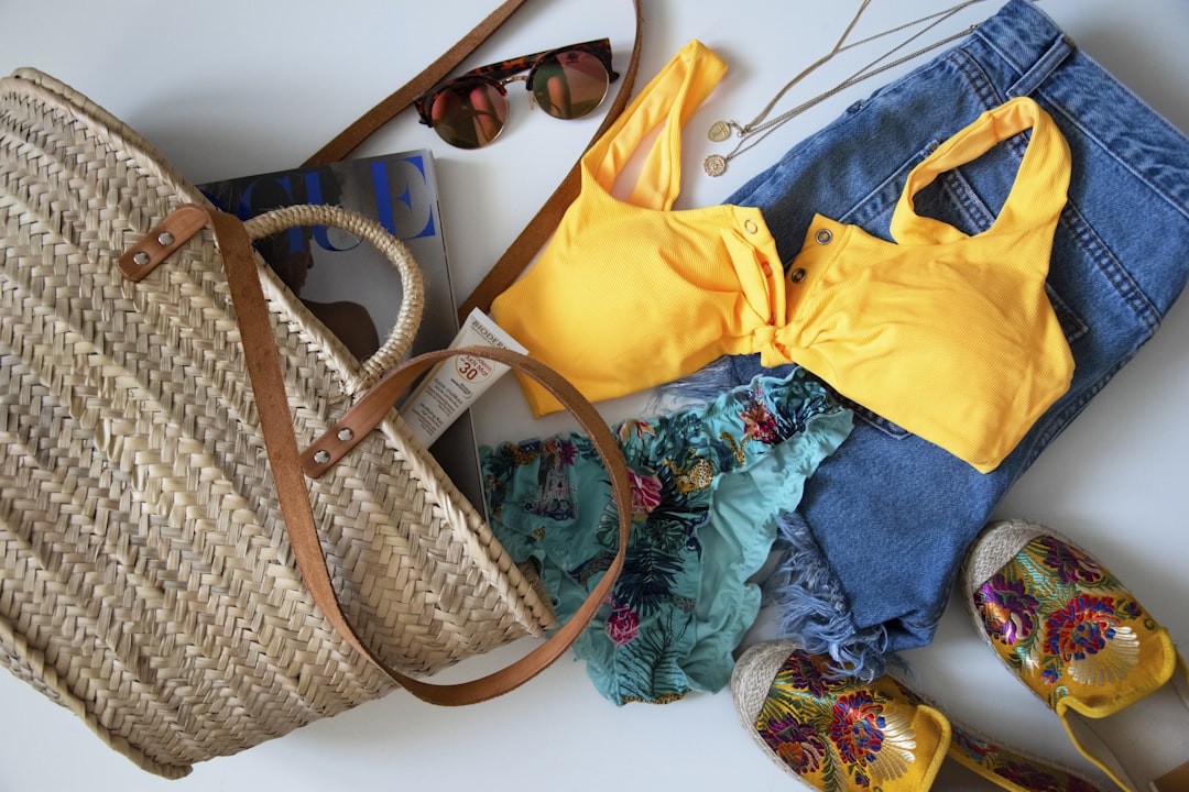 blue denim jeans beside yellow leather handbag, Beach essentials