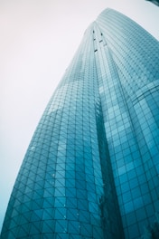 blue glass walled high rise building