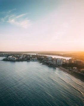Cronulla body of water near city buildings during daytime