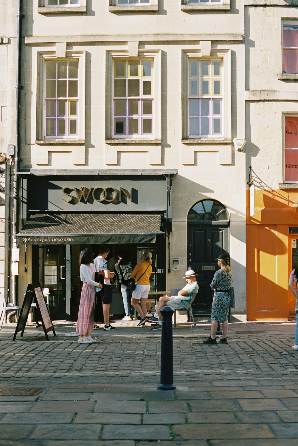 people walking on sidewalk near building during daytime