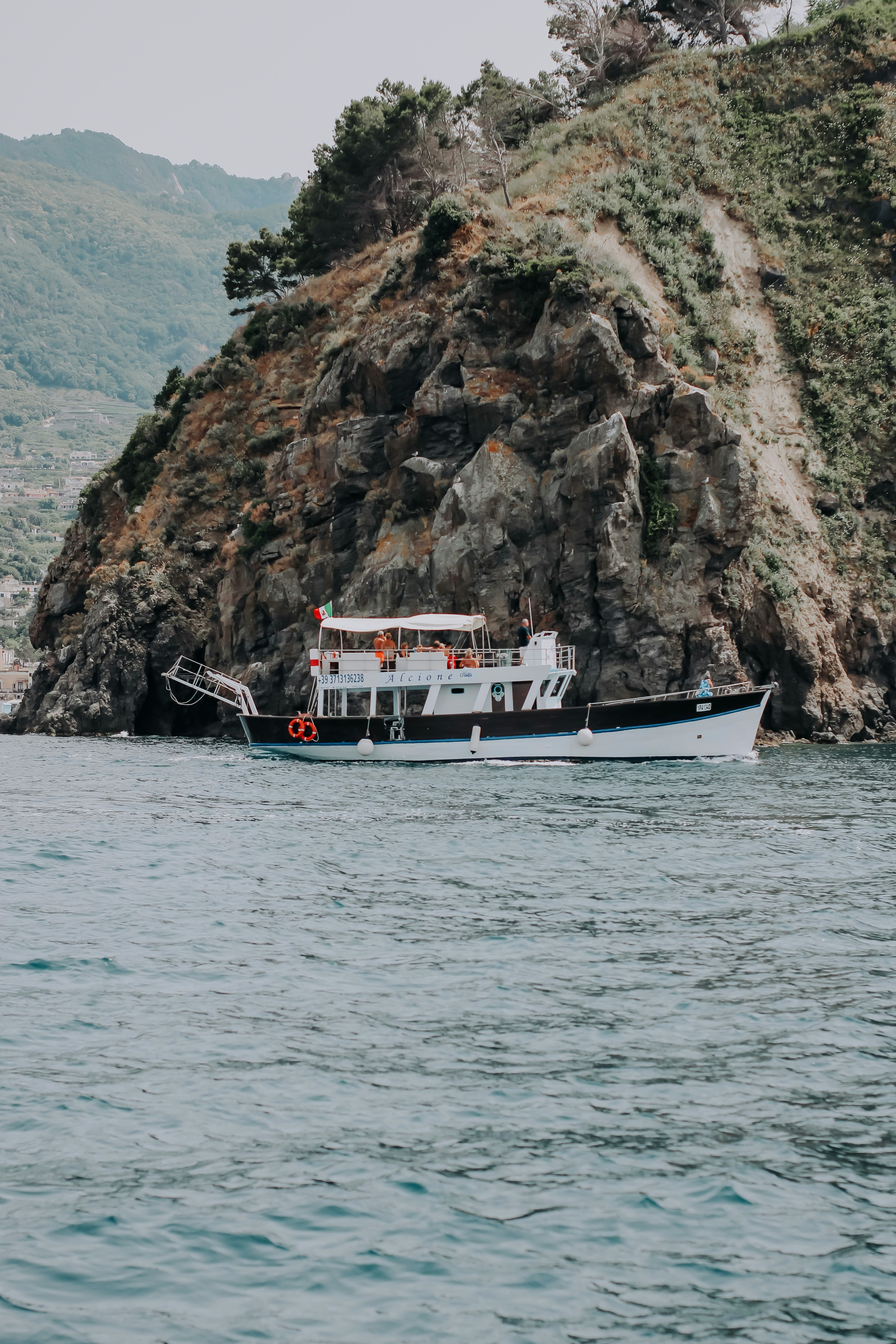 white and red boat on body of water during daytime