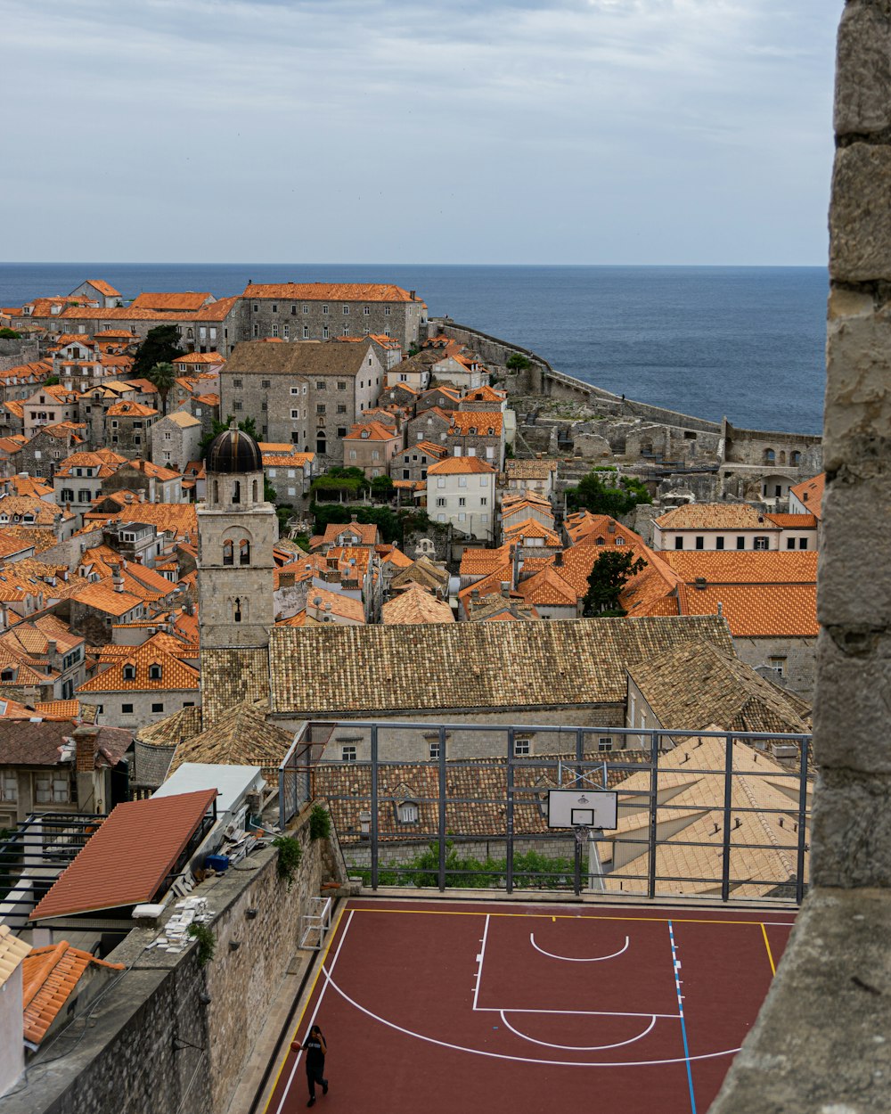 brown and white concrete houses near sea during daytime