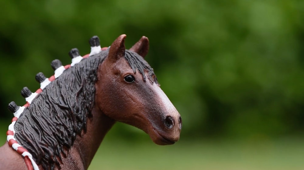 brown horse in close up photography during daytime