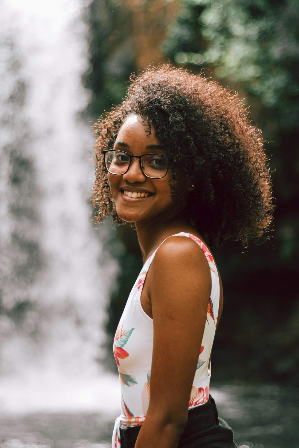 woman in white tank top wearing black framed eyeglasses