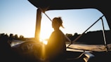 woman in black shirt sitting on chair during sunset