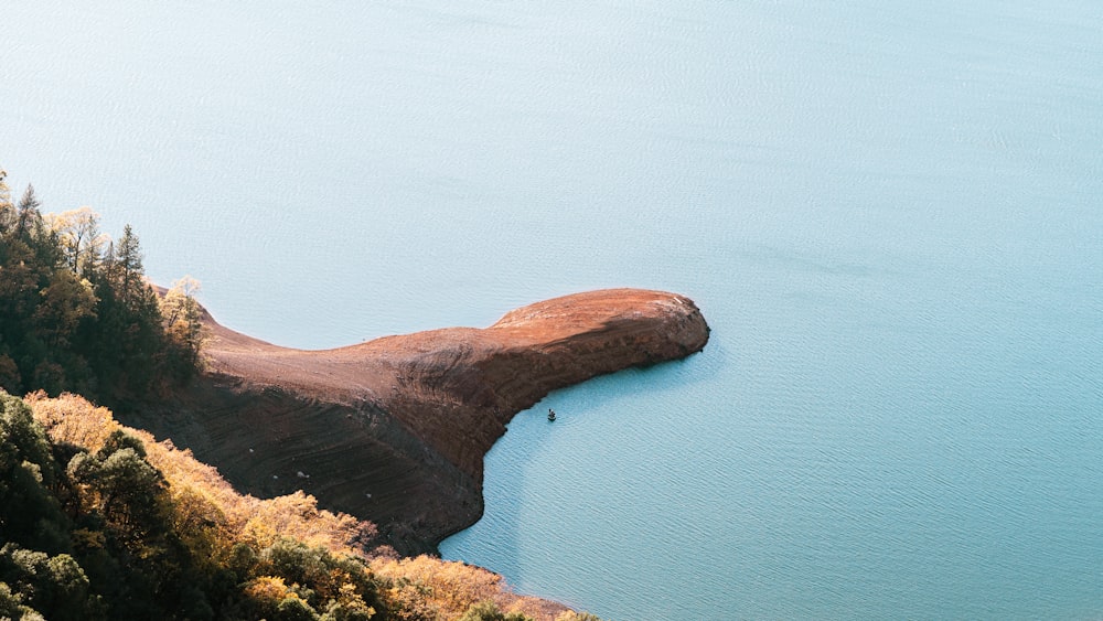 brown and green island on blue sea during daytime