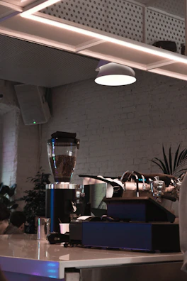 Elegant cafe interior showcasing premium espresso machines and polished countertops.