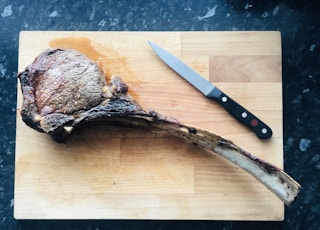 brown wooden handled knife on brown wooden chopping board