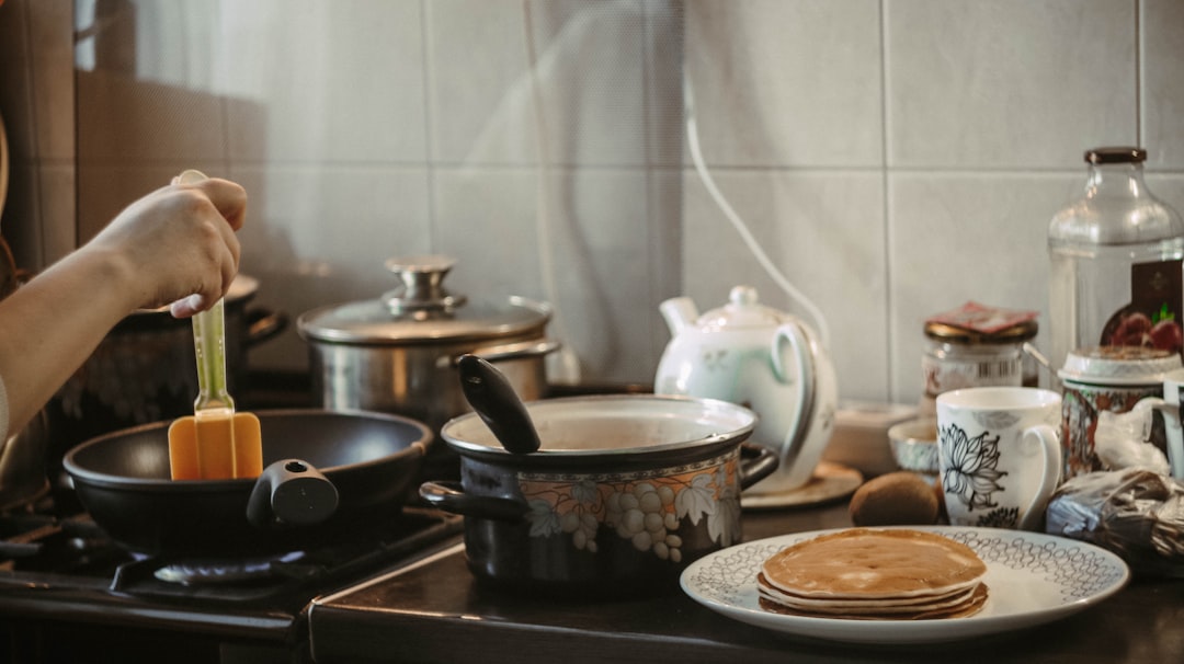 white and blue floral ceramic bowl on black stove