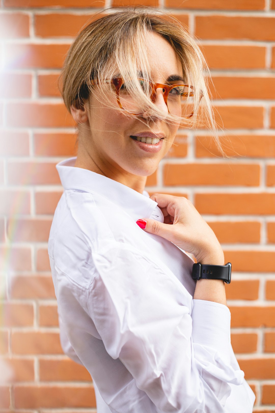 woman in white dress shirt wearing black smart watch