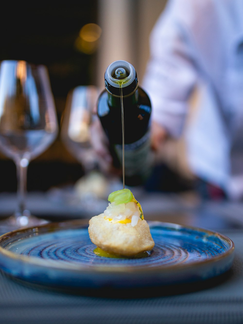 person pouring wine on clear wine glass