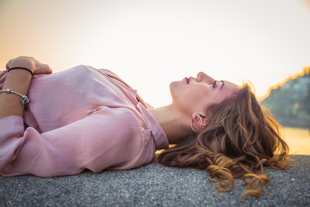 a woman laying on the ground with her eyes closed