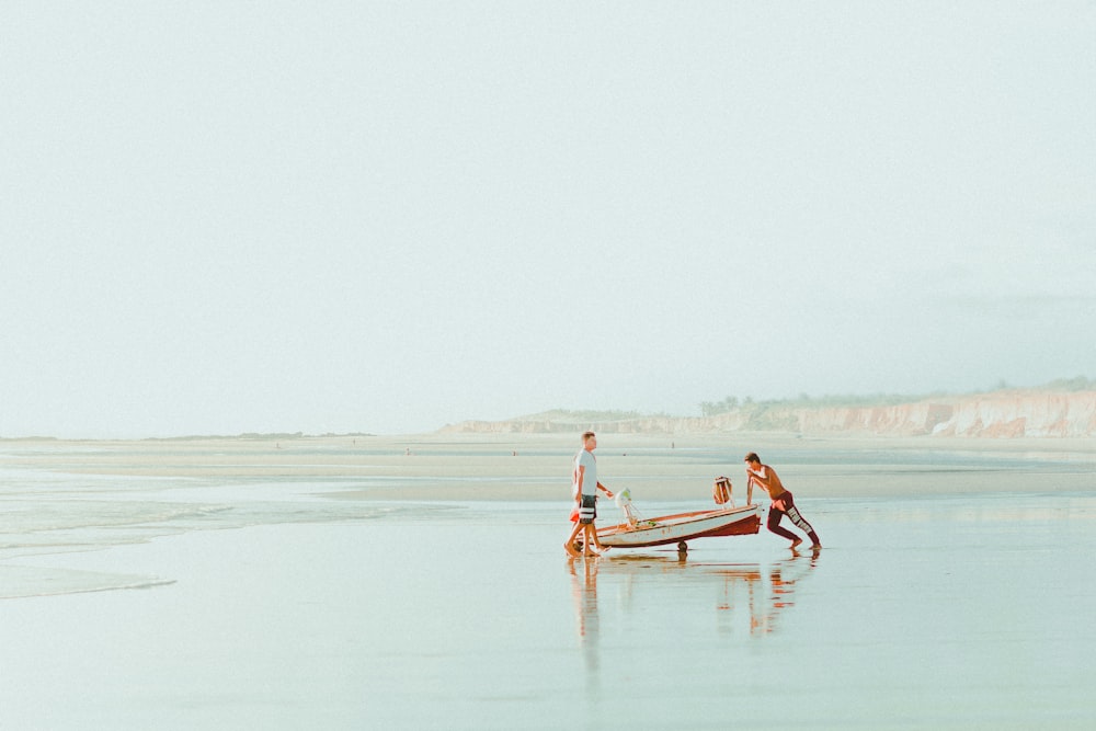 3 people on body of water during daytime