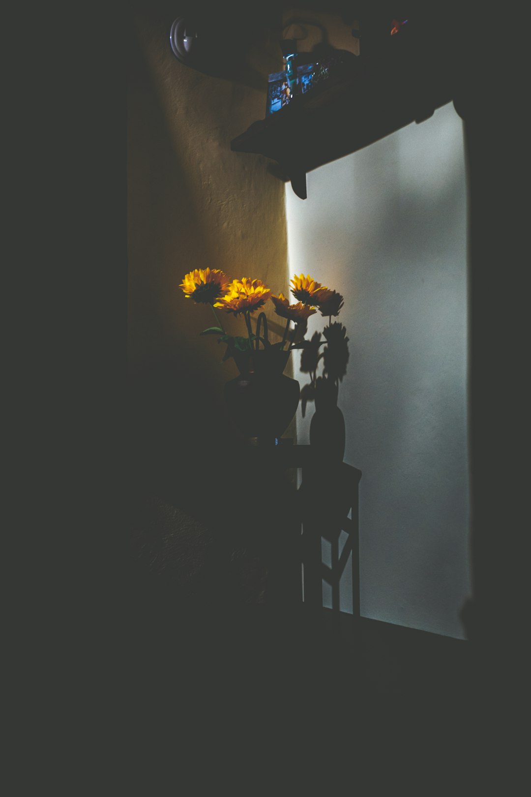 yellow flowers on black wooden table