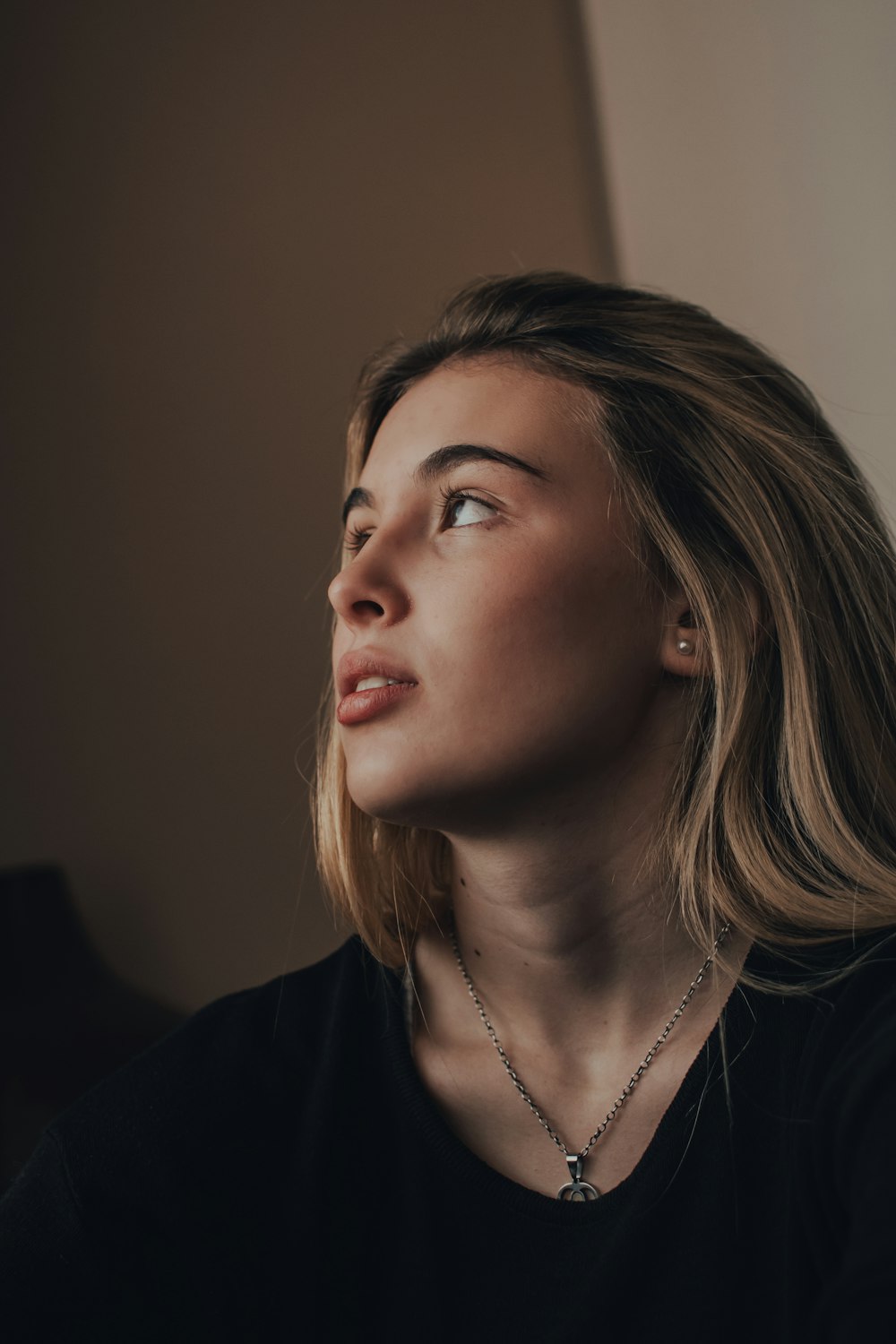 woman in black shirt wearing silver necklace