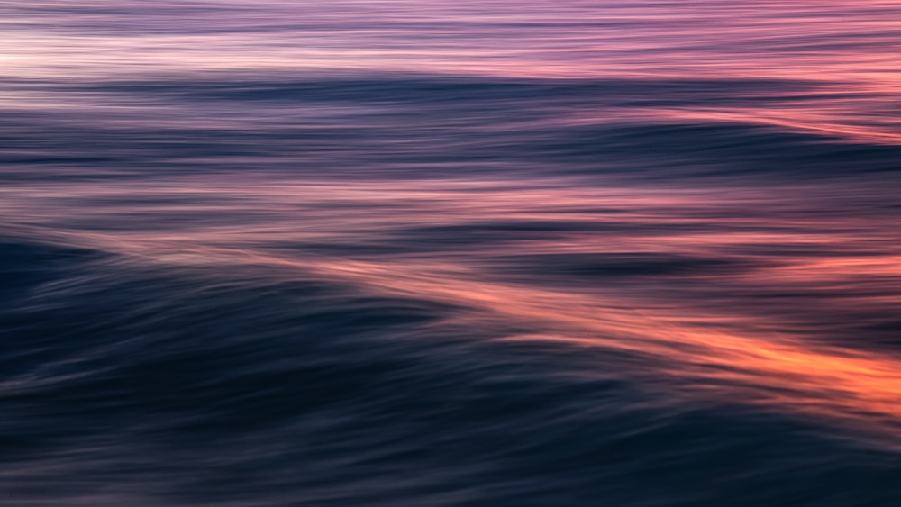 a blurry photo of a sunset over a body of water