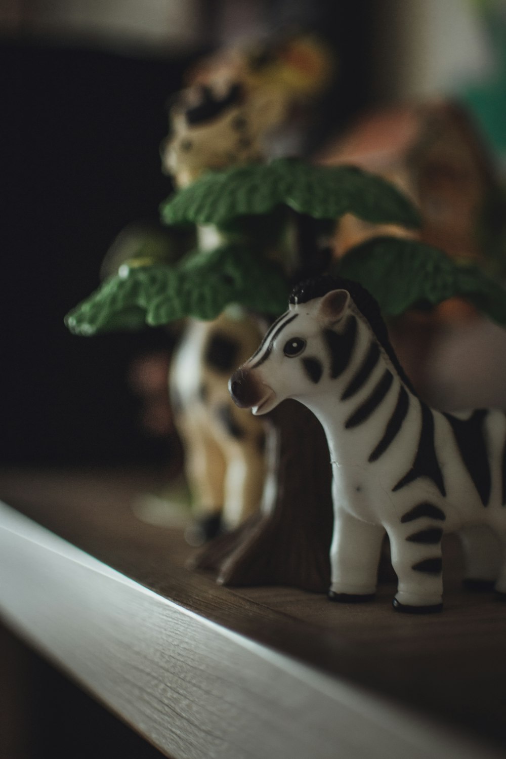 a close up of a toy zebra on a shelf