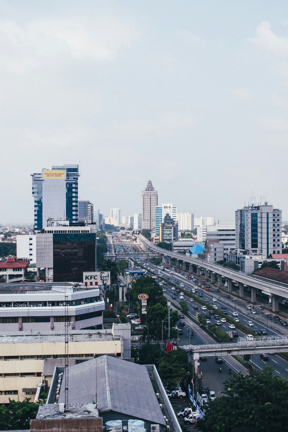 cars on road near city buildings during daytime