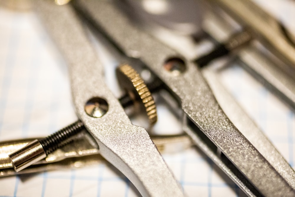 stainless steel tool on white paper