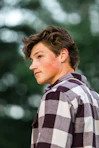man in red white and black plaid dress shirt