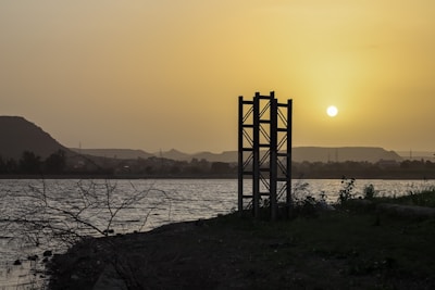 Sunset behind a traditional Finnish lakeside sauna with steam gently rising.