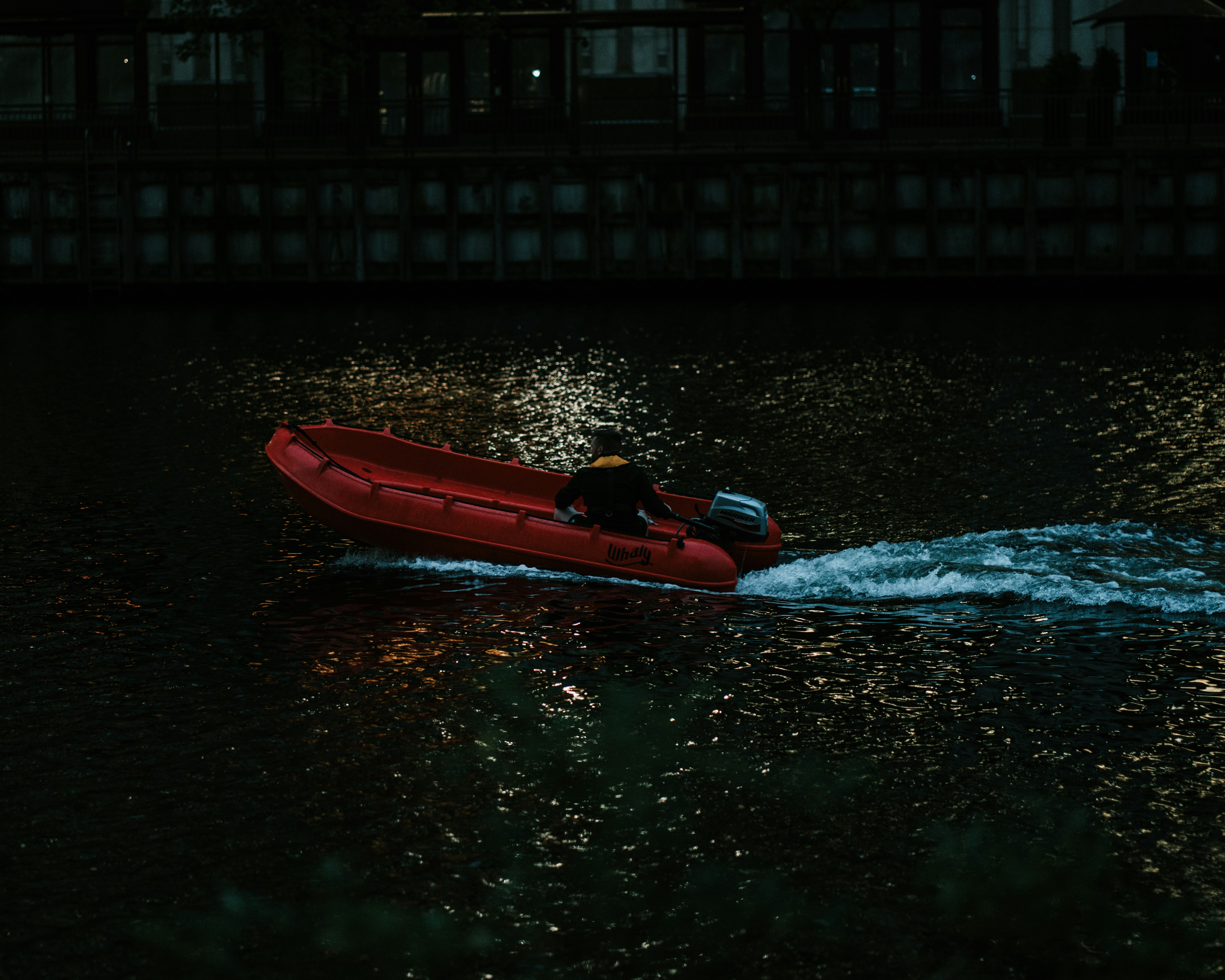 person in red kayak on water during daytime