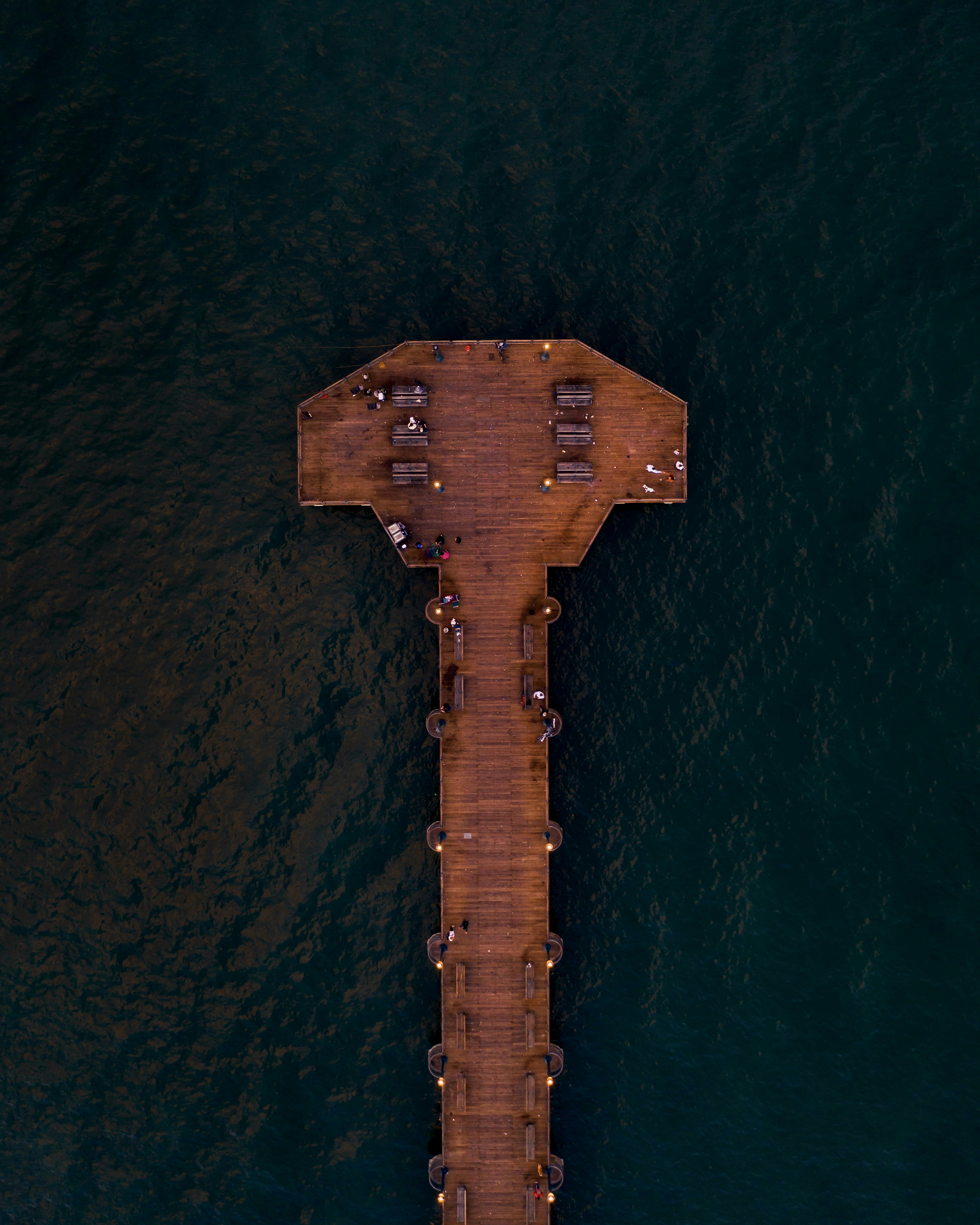 brown wooden dock on body of water