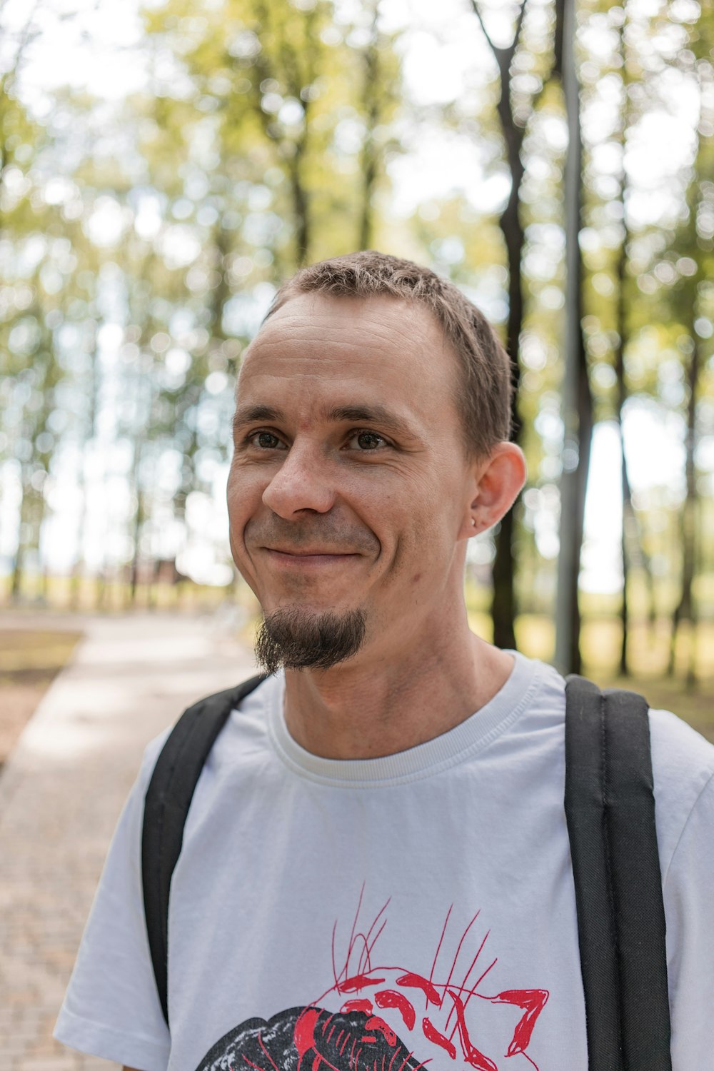 man in white crew neck shirt smiling