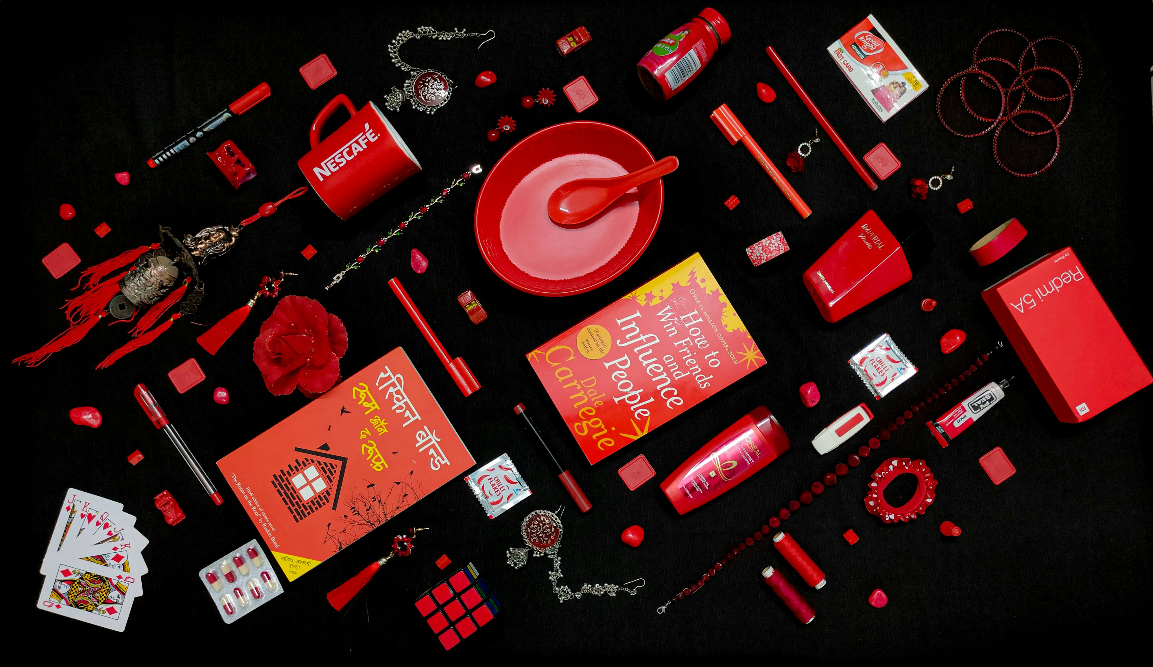 A carefully curated flatlay , where everyday red objects come together in a visually striking composition