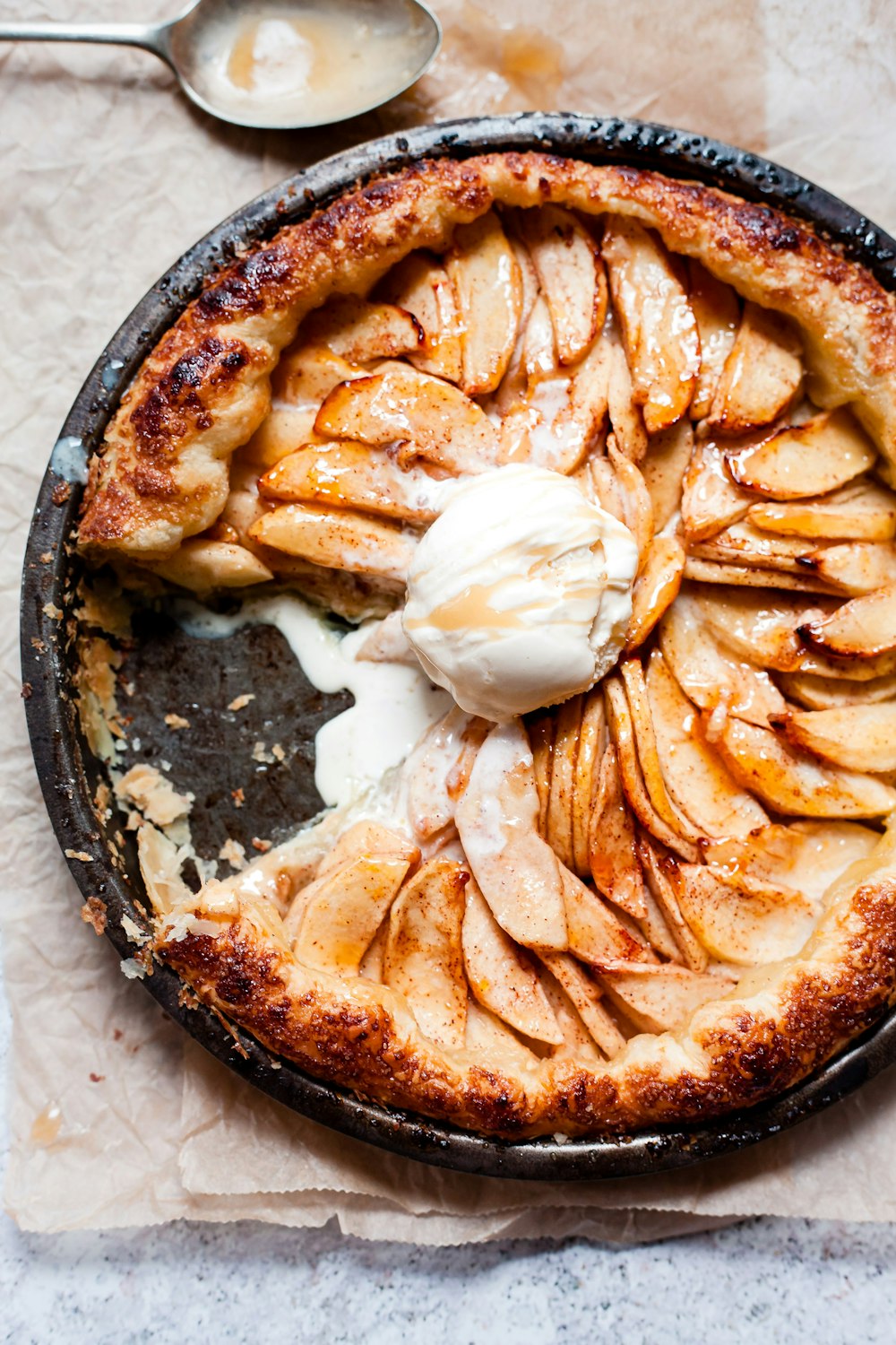 brown and white pastry on black round plate