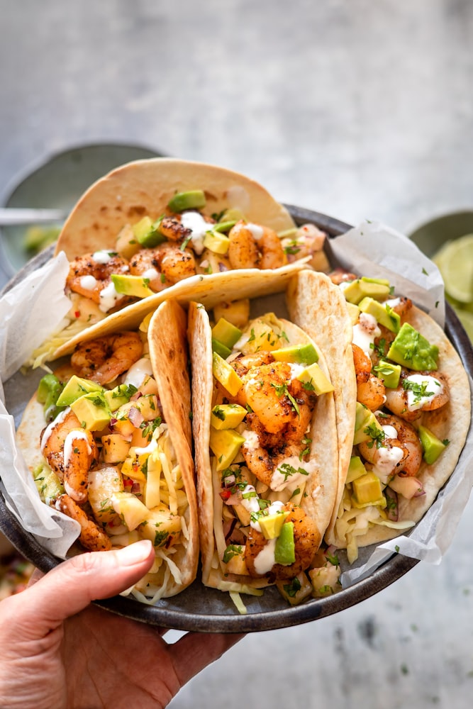 Prawn tacos with avocado and lime crema.  from unsplash}