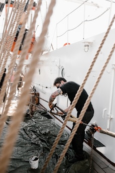 Technicians working on a ship’s engine deck under bright daylight