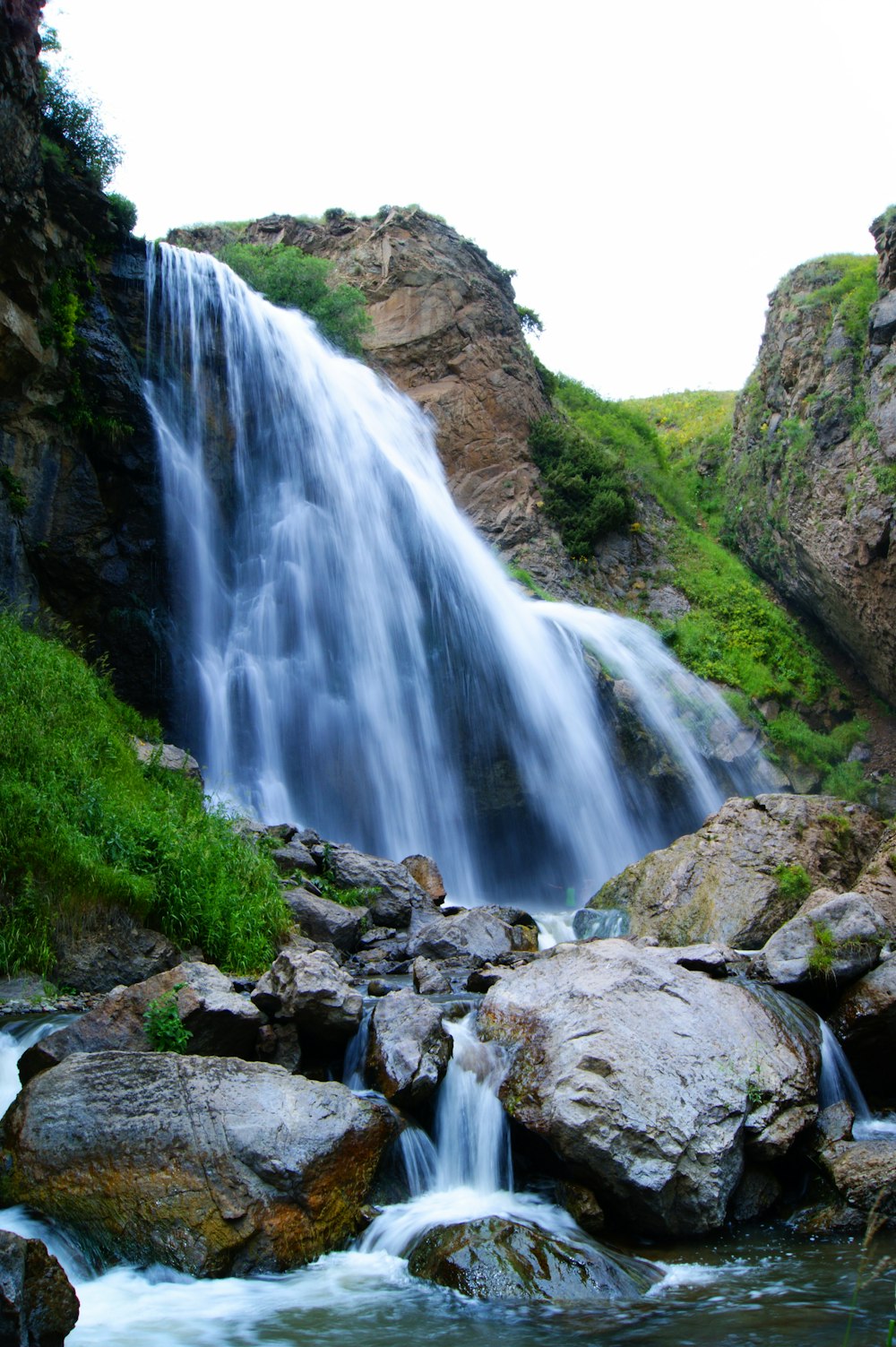 waterfalls on rocky mountain during daytime