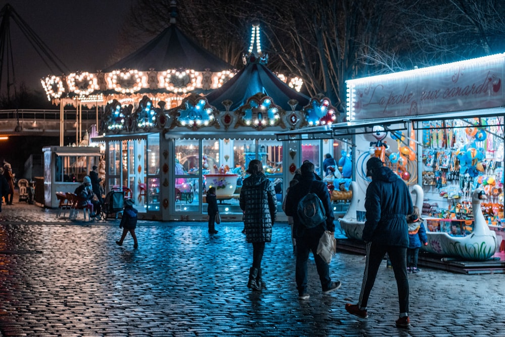 people walking on street during night time