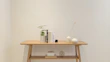 A simple resin table ornament sitting elegantly on a minimalist wooden desk.